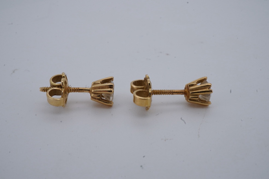 A pair of diamond ear studs, each weighing approximately 0.30 carats, mounted in gold, approximately 4.5mm diameter